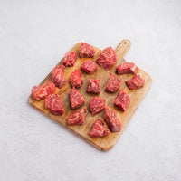 raw steak cuts on cutting board 