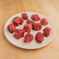 raw tenderloin pieces on white plate 