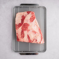 raw marbled short plate ribs on rack