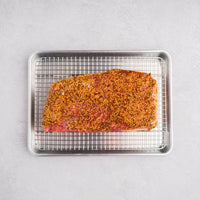 corned beef brisket on rack with seasoning 