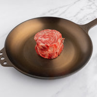 raw rolled cap of ribeye in cast iron skillet 