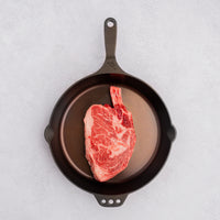 raw Cowboy steak in cast iron skillet 