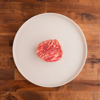 highly marbled raw Manhattan filet steak on white plate 