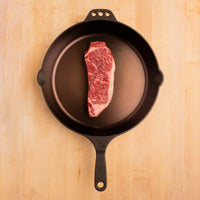 raw SRF Gold® NY strip steak in cast iron skillet |SRF Gold®|1"|1.5"