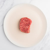 SRF Gold® ribeye filet 8 oz raw on a white plate 