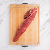 raw tenderloin roast on cutting board