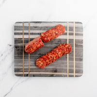 Sliced Fattoria salami on a cutting board