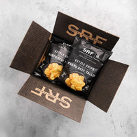 Open box containing SRF Kettle Chips on a gray background