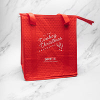 Red quilted bag with 'Cowboy Christmas' and 'SRF' text on a marble background