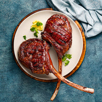 two tomahawk cooked on a plate 