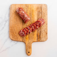 Sliced Truffle Salami on cutting board 