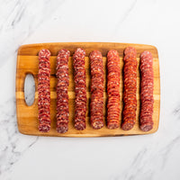 sliced salami on cutting board 