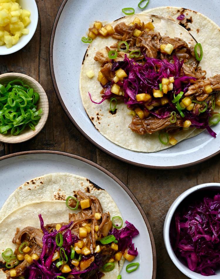 slow-cooker pork tacos plated with cabbage 