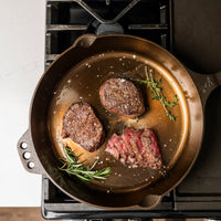 Smithey cast iron skillet with cooked steaks