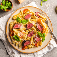 Penne pasta with Tenderloin pieces on plate 