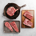 A collection of five different cuts of Snake River Farms American Wagyu SRF Gold® steaks, including cowboy, ribeye, and New York strips.