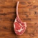 USDA Choice Tomahawk Steak on wood background