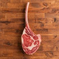 USDA Choice Tomahawk Steak on wood background