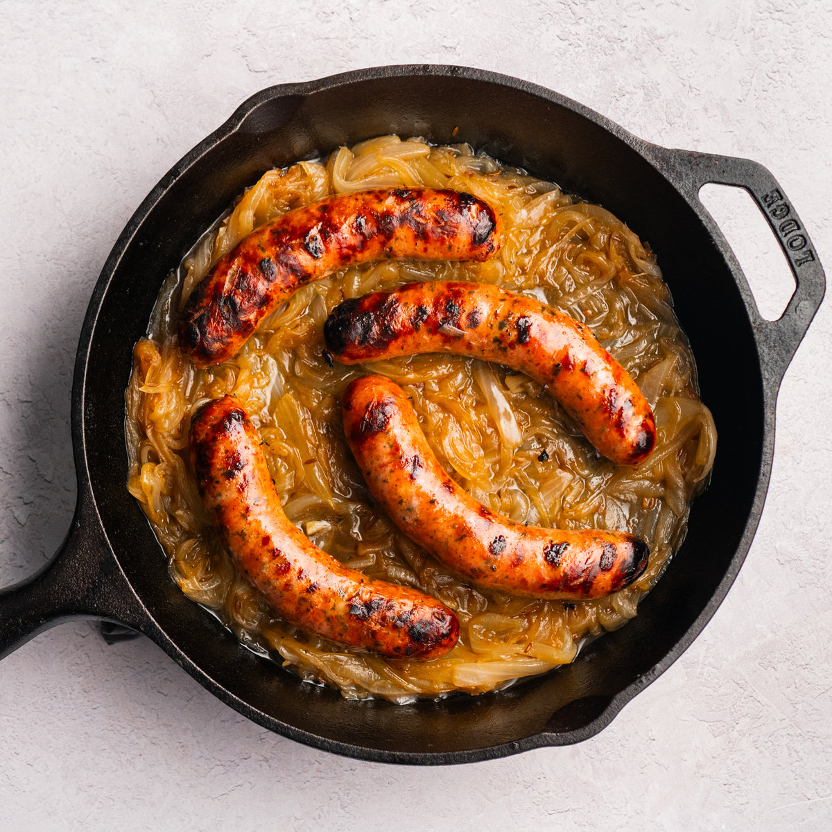 bacon bratwurst cooked in cast iron with onions