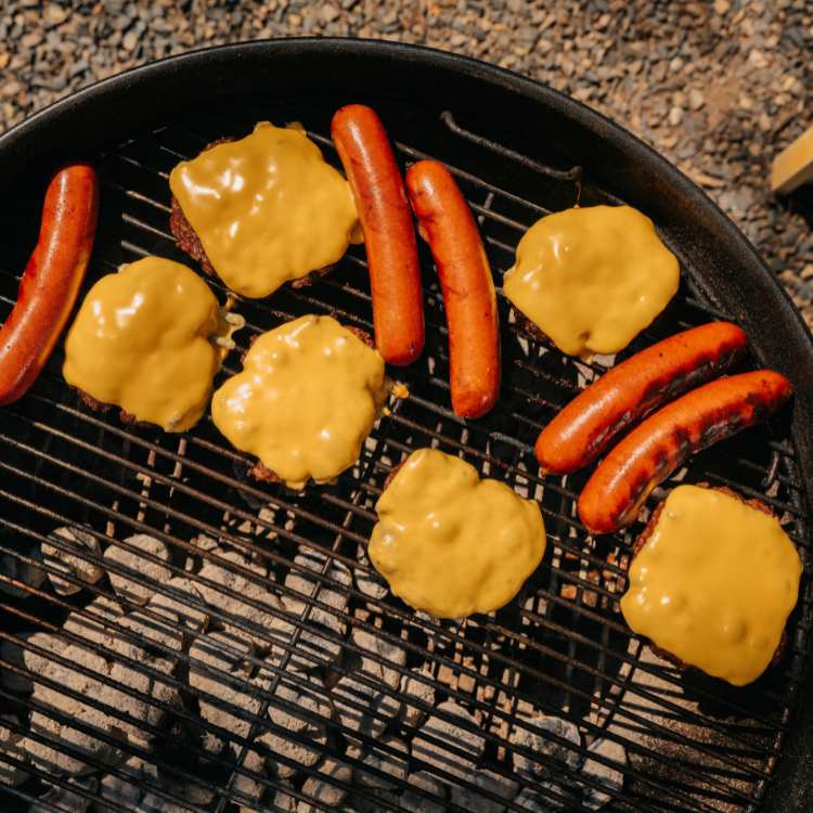 Hot dogs and cheeseburgers on a grill