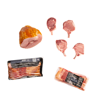 Meat products including a ham, bacon slices, and raw meat pieces on a white background