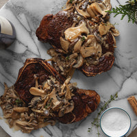 Bone in NY strip steak with mushroom sauce 