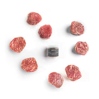Raw steaks arranged around a container labeled 'SRF' on a white background