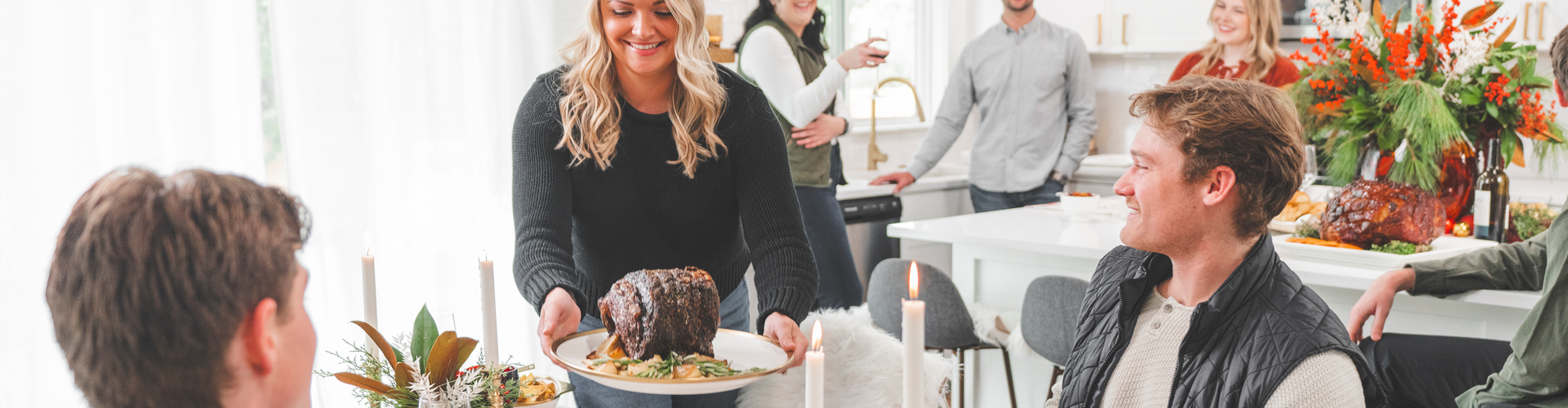 Woman serving prime rib at a table with people around