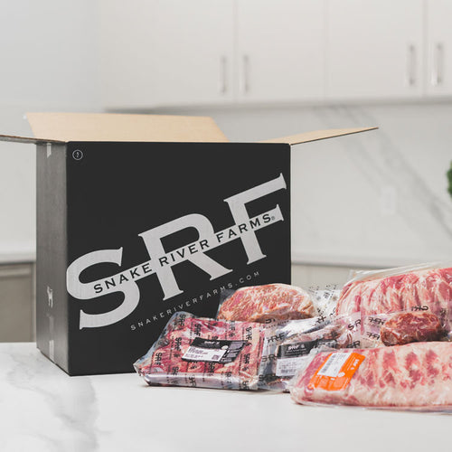 Packages of meat from Snake River Farms on a kitchen counter
