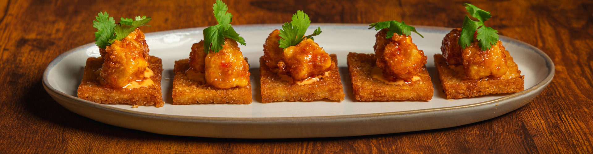 Plated halibut appetizers on a wooden table